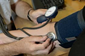 A doctor checking a patient's blood pressure