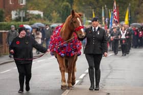 Samantha Wenn and Chester pictured proudly leading the Remembrance Day parade in Sandy