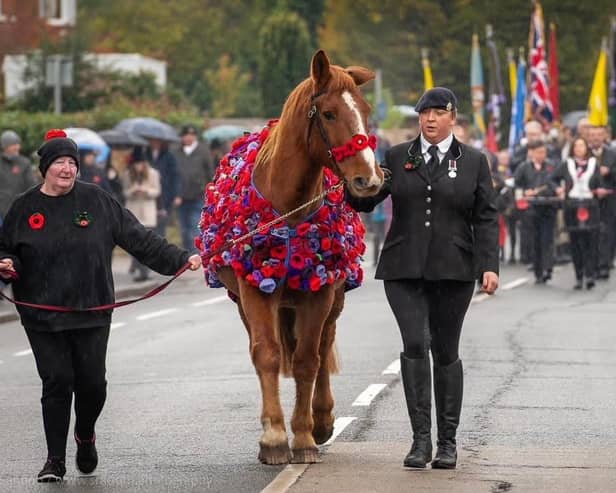 Samantha Wenn and Chester pictured proudly leading the Remembrance Day parade in Sandy