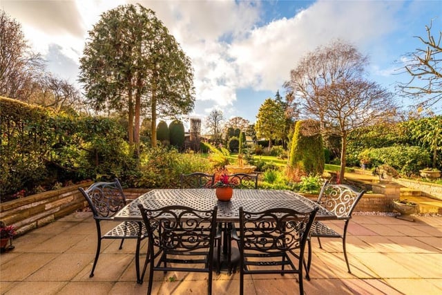 The gardens include a shaped central lawn with stocked borders and mature trees providing screening and privacy. It is also enclosed on all sides by high walling and mature hedgerow