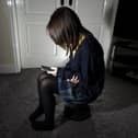 Photo of a young girl using a mobile phone. Picture; Peter Byrne/PA