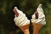 Two soft whipped ice cream cones with chocolate flakes