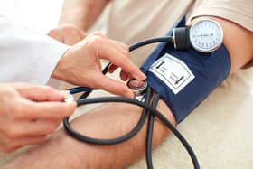 A doctor measures a patient's blood pressure.
