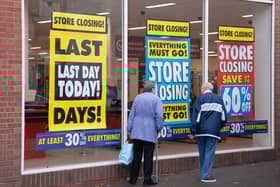 File photo of customers walking past a closing store