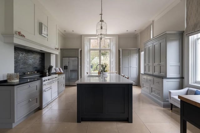 Complete with separate pantry and island seating, you'll stay warm with beautiful, heated limestone beneath your feet. Then throw open the double doors and look forward to lively dinner parties in your impressive dining room