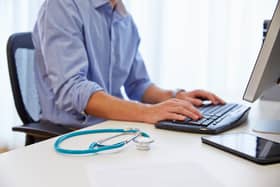 Close up of doctor working at computer