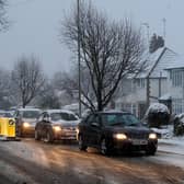 Cars struggle up a hill in Market Harborough, due to snow and slush on the roads. Picture: Andrew Matthews/PA