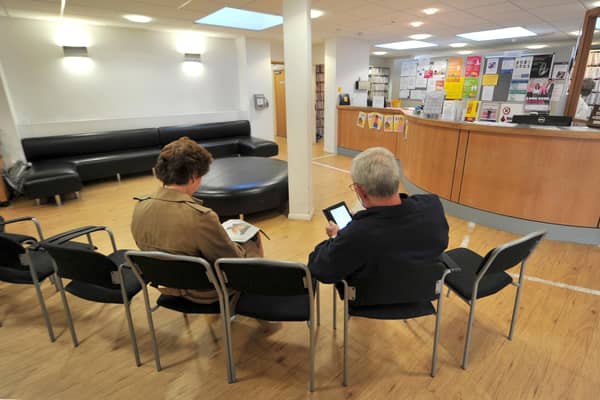 File photo of patients sitting in the waiting room at a GP practice.