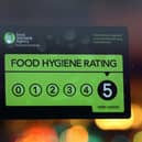 A Food Standards Agency rating certificate is pictured in the window of a restaurant. (Photo by Carl Court/Getty Images)