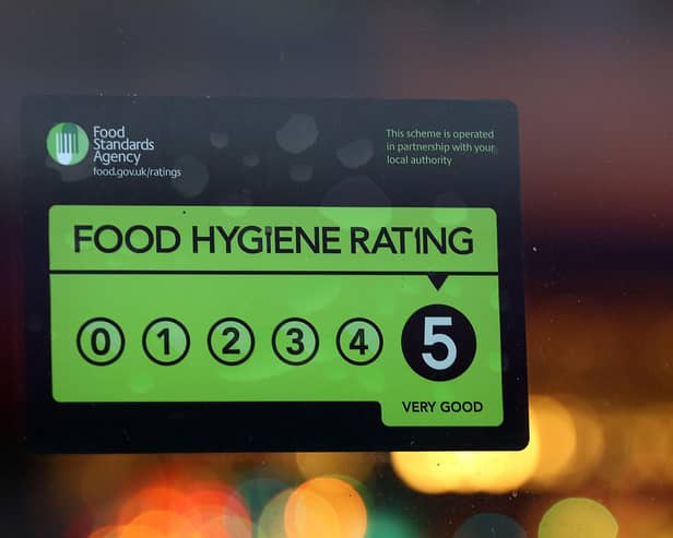 A Food Standards Agency rating certificate is pictured in the window of a restaurant. (Photo by Carl Court/Getty Images)