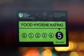 A Food Standards Agency rating certificate is pictured in the window of a restaurant. (Photo by Carl Court/Getty Images)