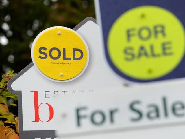 File photo of a sold and for sale signs.