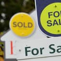 General view of Sold and For Sale signs outside a block of flats