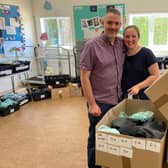 Amy and Mark Foster with the uniform donations.