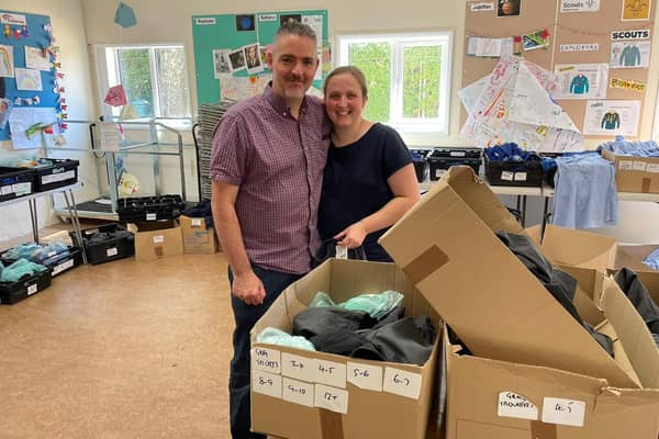 Amy and Mark Foster with the uniform donations.