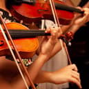 File photo of children playing violins.