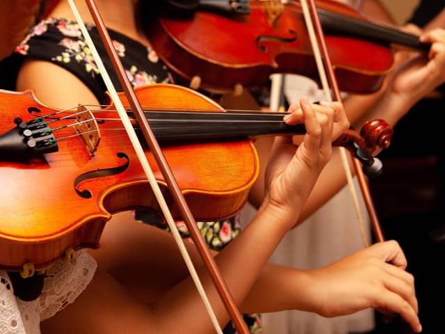 File photo of children playing violins.
