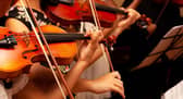 File photo of children playing violins.
