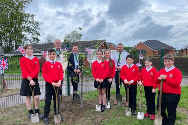 Pupils are joined by, back row from left, Shefford Mayor Ken Pollard, Bedfordshire Schools Trust Chief Operating Officer Craig Smith, and Robert Bloomfield Academy Head of School Colin Marshall, for the Coronation tree planting.