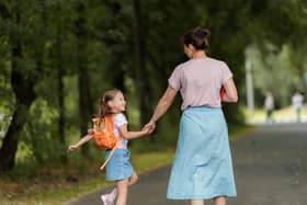 Mum and daughter holding hands