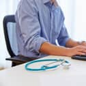 Close up of doctor working at computer