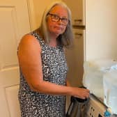 An Everton resident fills up her kettle from a water container. Credit: Cllr Les Alexander.