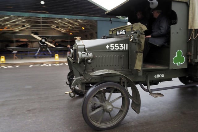 A First World War lorry passes a biplane
