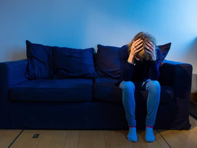 Woman with her head pin her hands. Picture: Dominic Lipinski/PA Wire