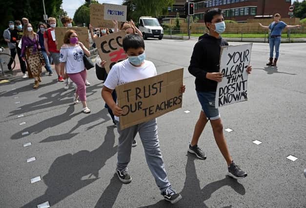 Students hold placards as they take part in a protests over exam results (Getty Images)