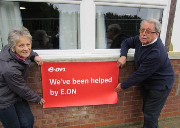 David and Doris Boswell, long-time members of Langford Football Club, in front of the newly-installed double-glazed windows.