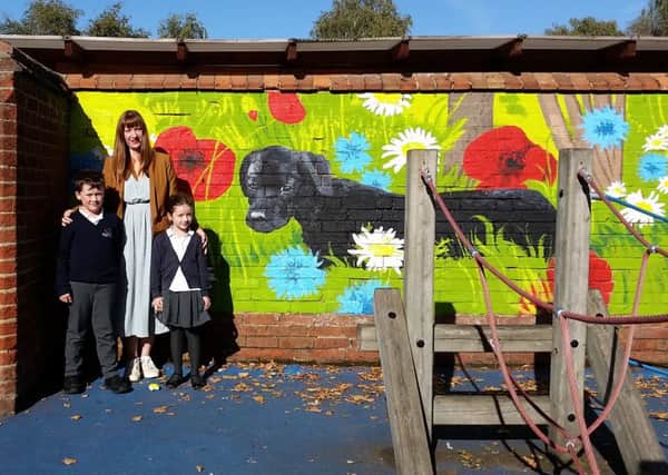Clara Nicoll with Lenny and Layla, by the illustration at Everton Heath Primary School.