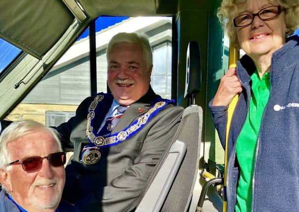 Stephanie Kirby and Clive Lester (left), on behalf of Whitbread Wanderbus Ltd, with Tony Henderson, leader of Bedfordshire Freemasons.