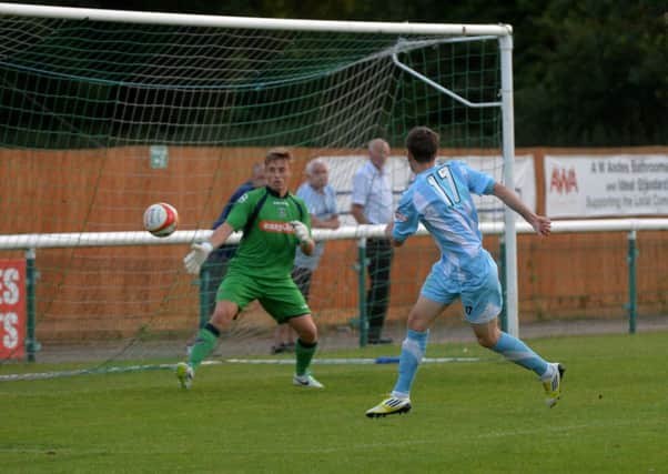 Town keeper Ben Barnes is powerless to prevent Alex Witham volleying Biggleswade into the lead. Pic: June Essex