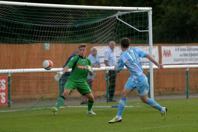 Town keeper Ben Barnes is powerless to prevent Alex Witham volleying Biggleswade into the lead. Pic: June Essex