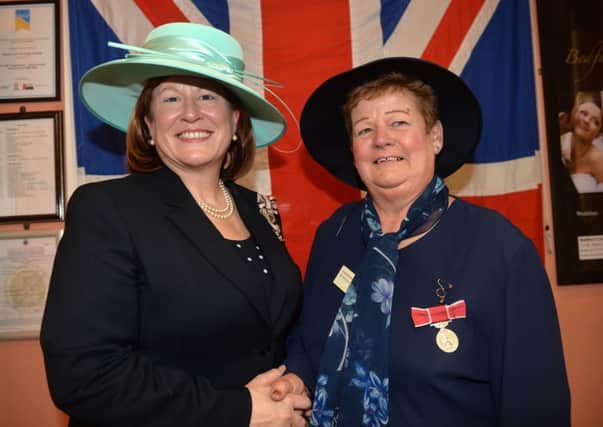 Lord Lieutenant Helen Nellis  presents Mrs Gillian Wood with her British Empire Medal.