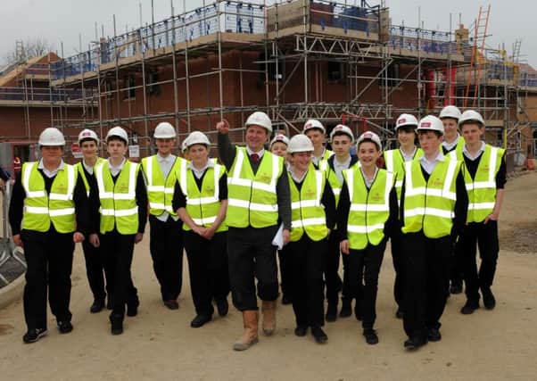 Linden Homes Midlands site manager Carl Haskell shows students from Stratton Upper School around the Harvest Meadow development in Dunton