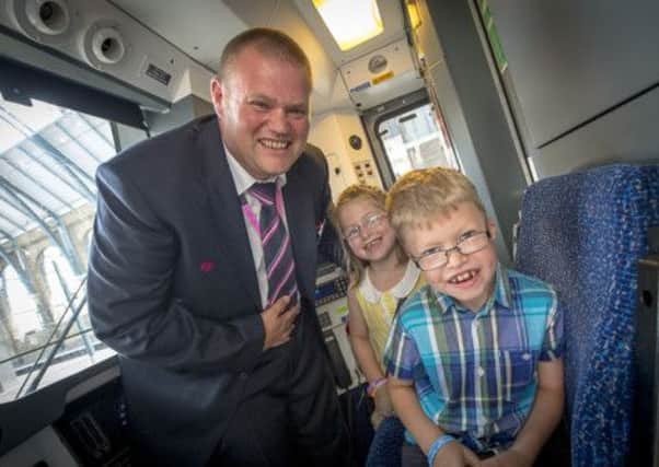 A train has been renamed and rebranded to help raise awareness of the Max Appeal charity. Mark Tripp is pictured here with daughter Zoe and son Adam. PNL-140731-113925001