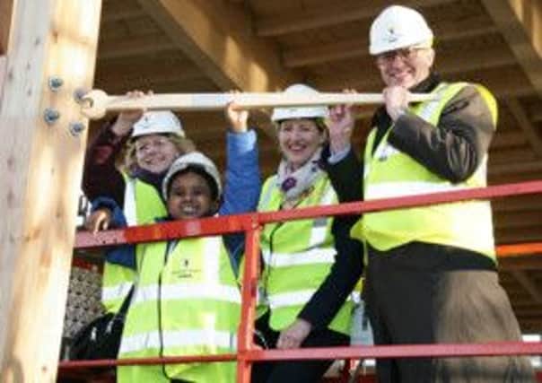 William Story tightens the final bolt at the new St Andrew's Lower School campus in Biggleswade. PNL-151201-160807001