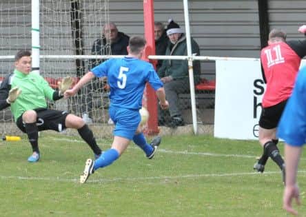 Kieran Turner scores the first of his hat-trick for Tring Athletic against Stotfold. Picture (c) Colin Sturges
