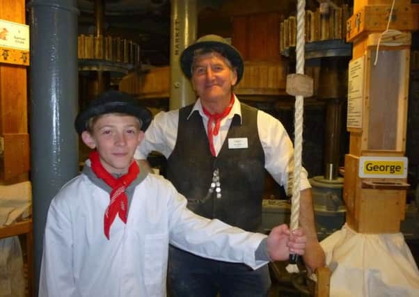 Archie Chenery, 12, with Ray Kilby of the milling team at Stotfold Watermill, bidding for world record of operating two millstones.
