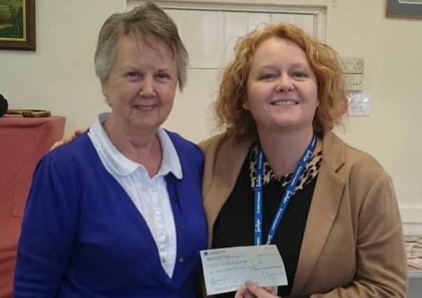 Potton Parish  Lunch leader Ann Sydney presents cheque to Fay Boissieux From St John's Hospice.