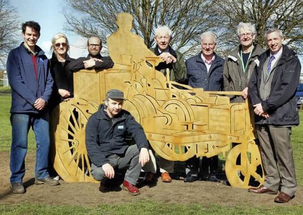 Artist Martin Heron (kneeling) with representatives of BRCC, the Fen Reeves of Biggleswade Common, Biggleswade Town Council and Biggleswade History Society with the Dan Albone sculpture.