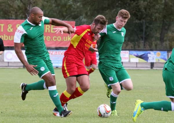 Banbury United's Conor McDonagh takes on Biggleswade Town's Gavin Hoyte and Ian Rees