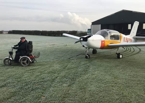 David Bell, retired farmer and active pilot with Muscular Dystrophy, manoeuvres one of his light aircraft with the assistance of his TGA Supersport mobility scooter.