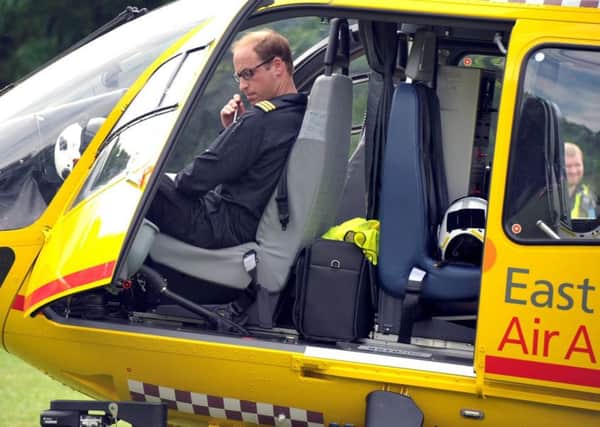FILE PICTURE - Prince William in his East Anglian Air Ambulance in Wisbech Park, Cambs. July 16, 2015. See MASONS story MNLETTER: Prince William has penned a heartwarming letter thanking his colleagues at the East Anglian Air Ambulance as he clocks off on his final shift. The Duke of Cambridge leaves his role as a pilot for the East Anglian Air Ambulance today (thu) after two years of service. As he departs to begin full time Royal duties, he sent a letter to a local newspaper telling of his pride at doing the job with the charity. In the letter, Prince William said his two years in the role had exposed him to 'moments of extreme emotion' and he promised to continue to support emergency services staff after his time with the charity is up.