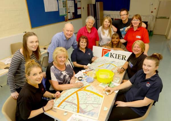 Kier Living Eastern workers helping to create a mosaic for Potton