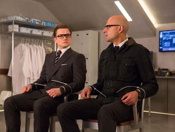 Taron Egerton as Eggsy and Mark Strong as Merlin