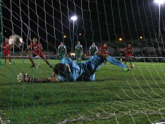 Rhys Hoenes' penalty is saved by Liam Gooch as Kettering Town were held to a 0-0 draw at Biggleswade Town. Picture by Peter Short