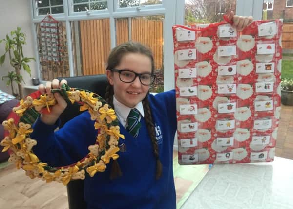 Georgina with the items she has made and is selling to raise money for charity